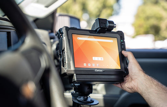 Featured image showing a man interacting with a Getac ZX80 rugged tablet in a RAM Powered Dock