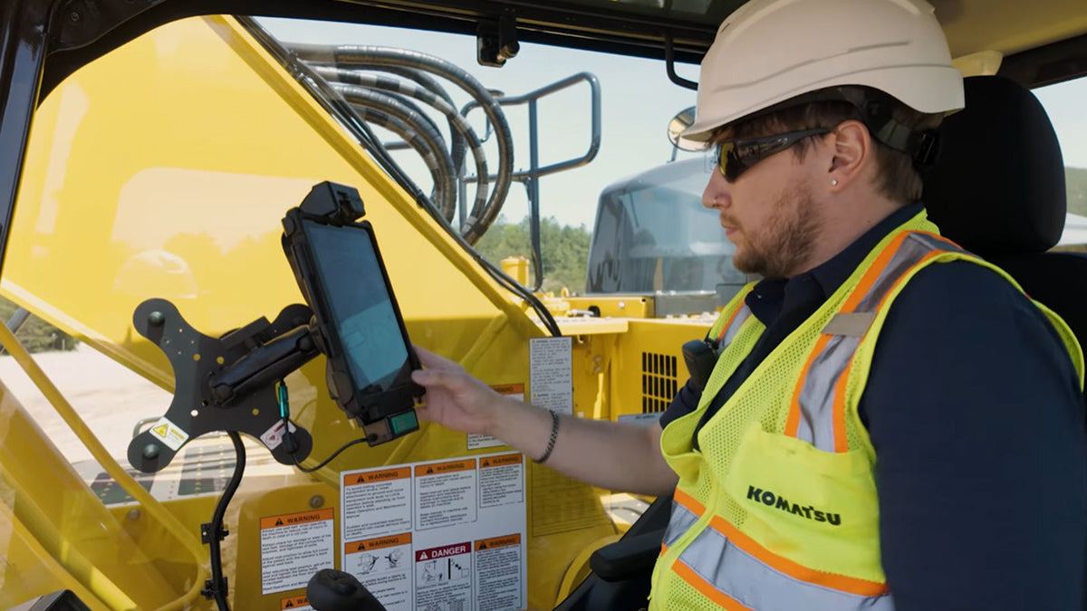 Image of a man working construction in an excavator