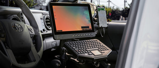 A mobile office set up in the passenger seat of a car with RAM® Mounts 
