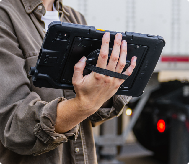 In use image showing the back of a Zebra ET40 device in an Intelliskin with someone holding it using GDS accessories