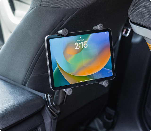 Image of man tapping on an iPad Pro mounted in a universal tablet holder mount in a car