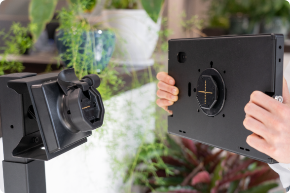 Image showing a close-up of a tablet in a Safe-Case being docking on to a standing Kiosk dock.